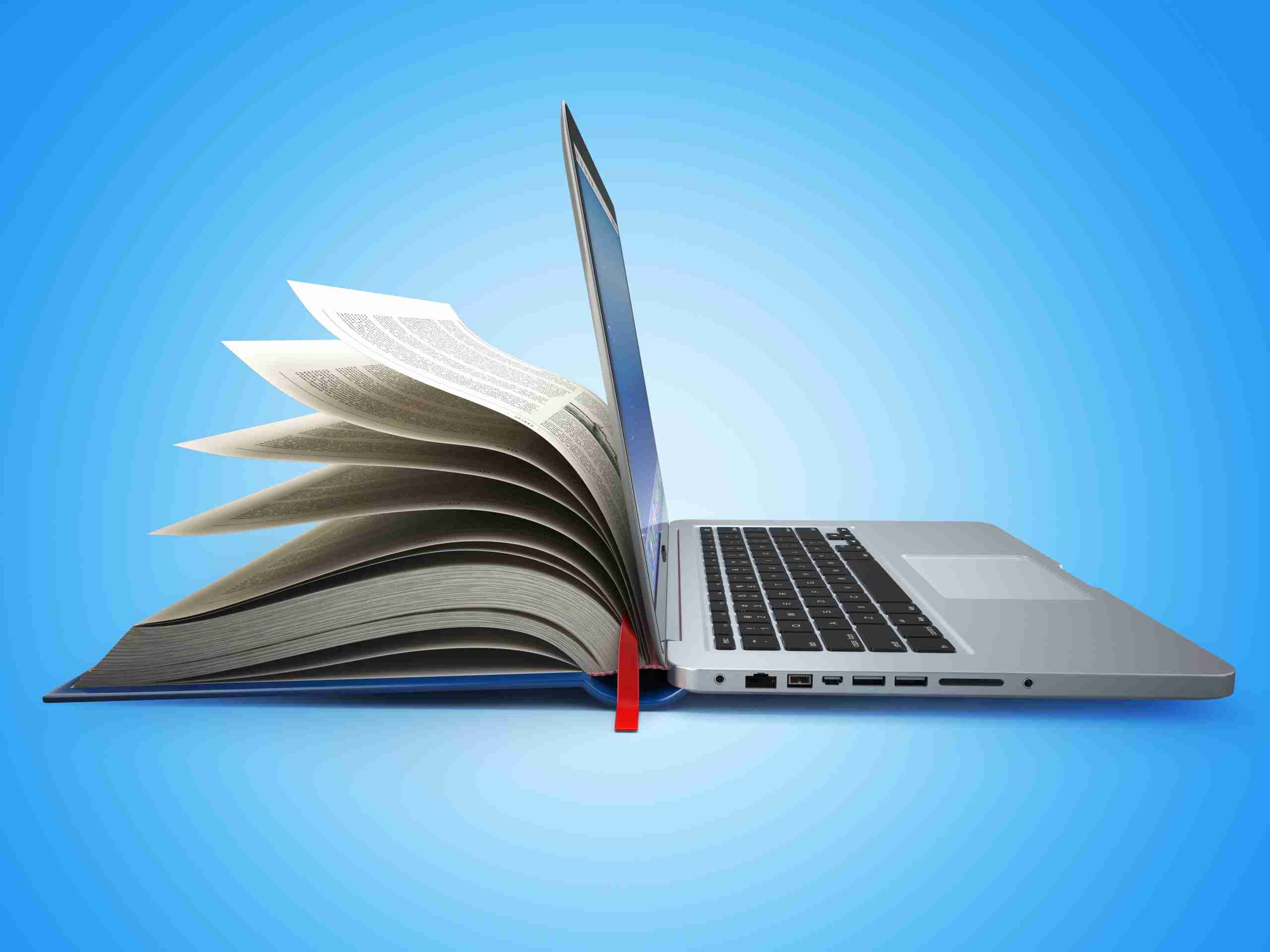 concept image of combined book learning and online learning - half a book lying on its spine on the left side, and an open laptop on the other side.