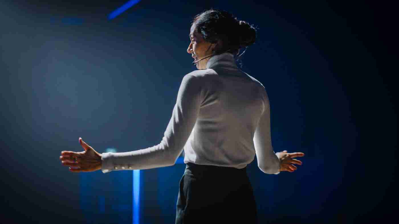 Image of a woman from the back giving a presentation