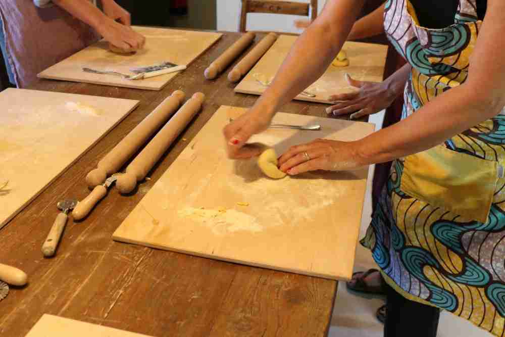Hands of people making pasta in a cooking class