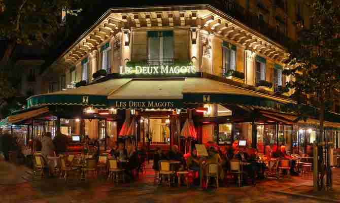 Exterior of the famous Les Deux Magots cafe in Paris at night - Petr Kovalenkov/Shutterstock.com