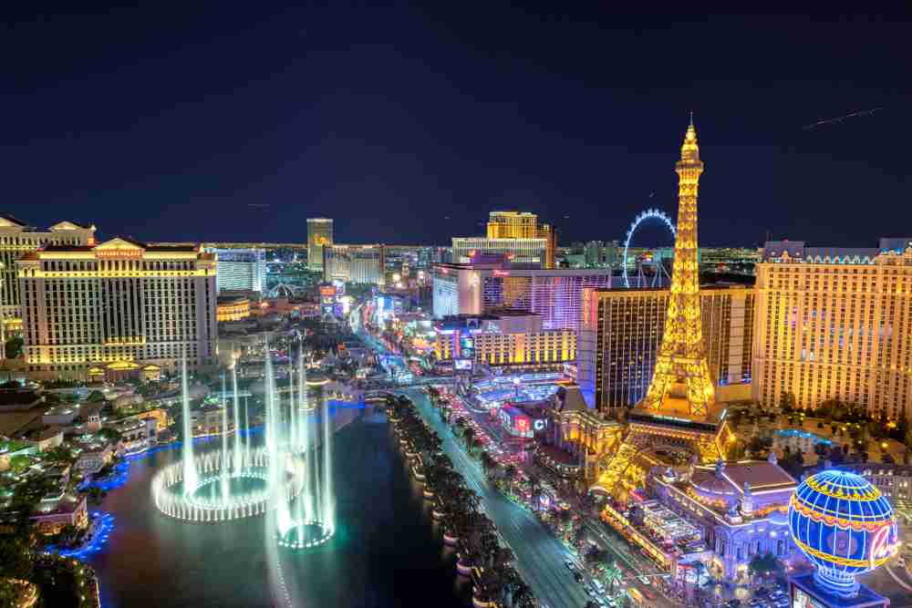 The glittering Las Vegas strip at night with the Bellagio Hotel on the left, Paris on the right and a view down the strip including Caesar's Palace, the Flamingo and Mirage hotels in in the background.