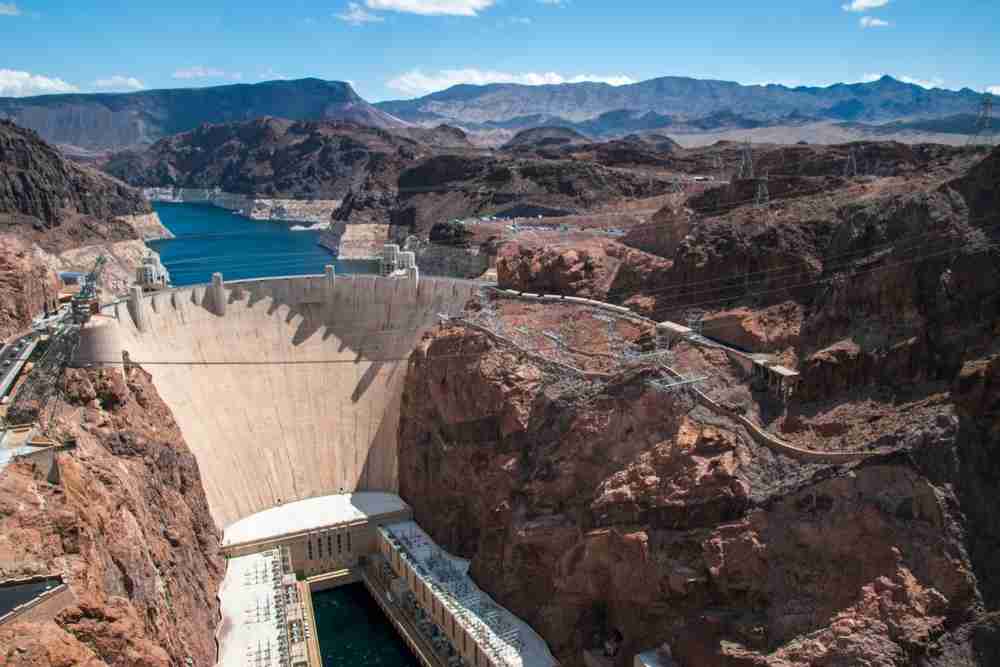 A daytime aerial view of the majestic Hoover Dam showing its enormous size.
