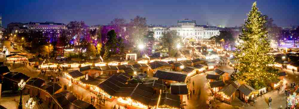 Aerial view of the vast Vienna Christmas Market at night.