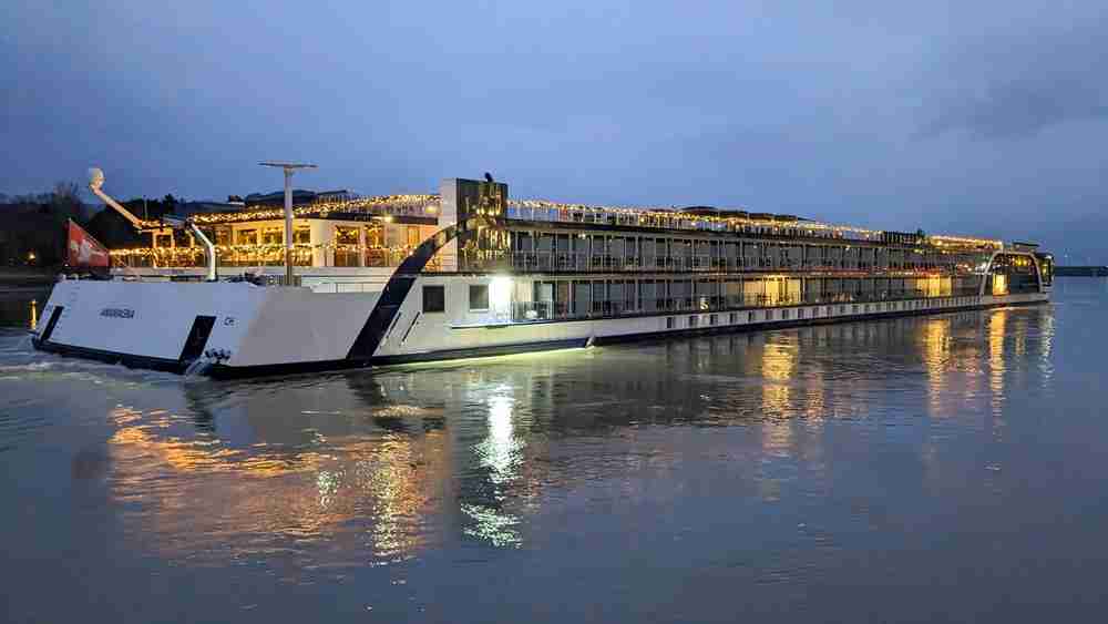 The Amamagna ship decorated with festive Christmas lights on its outside rails.