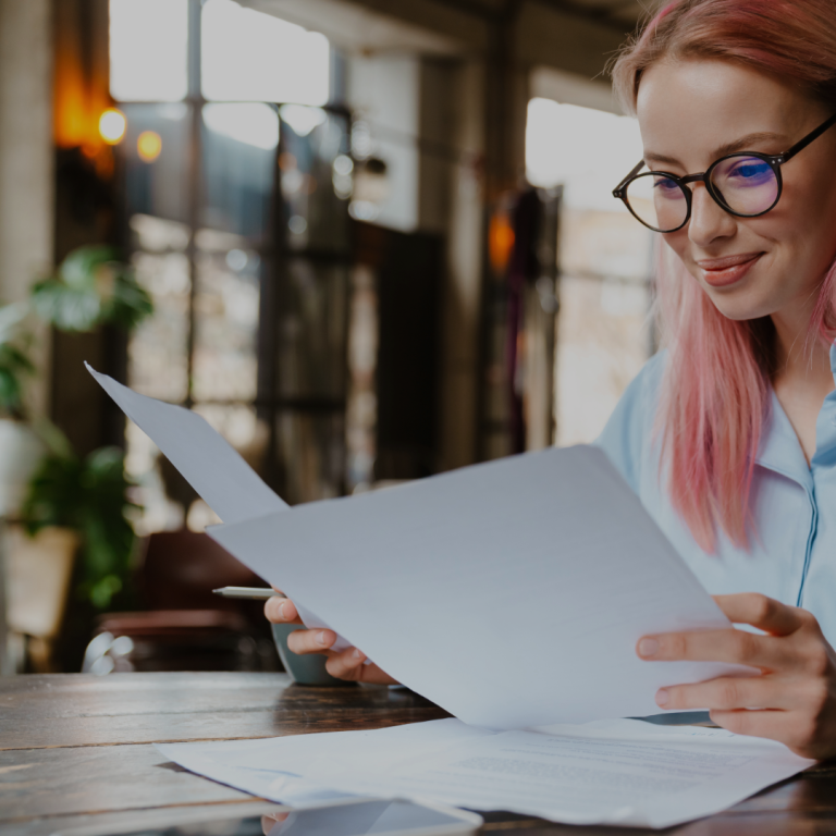 Woman wearing glasses and reading documents