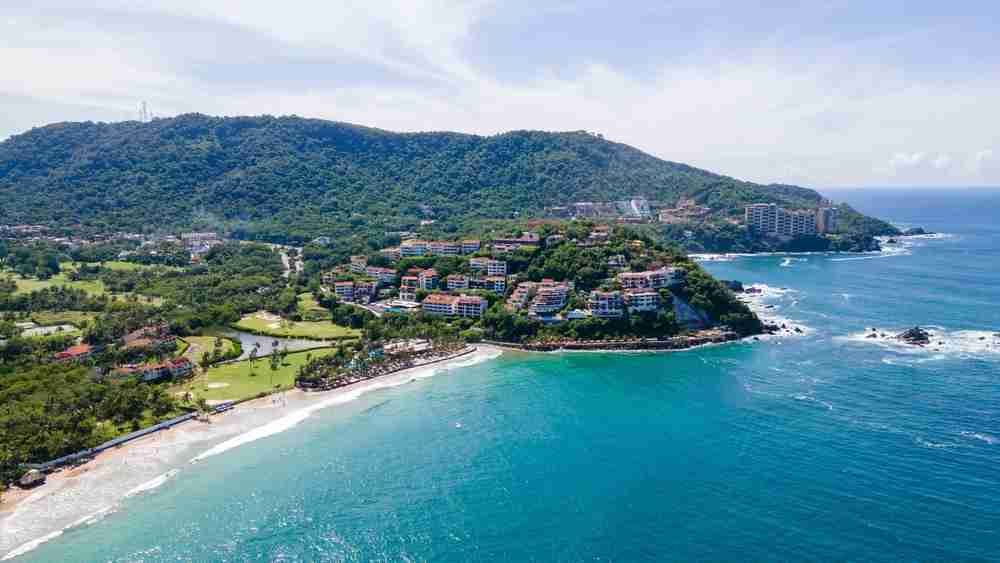 View of the resort area of Ixtapa. The golf course is on the left, the resorts begin on the right, and all face the blue ocean