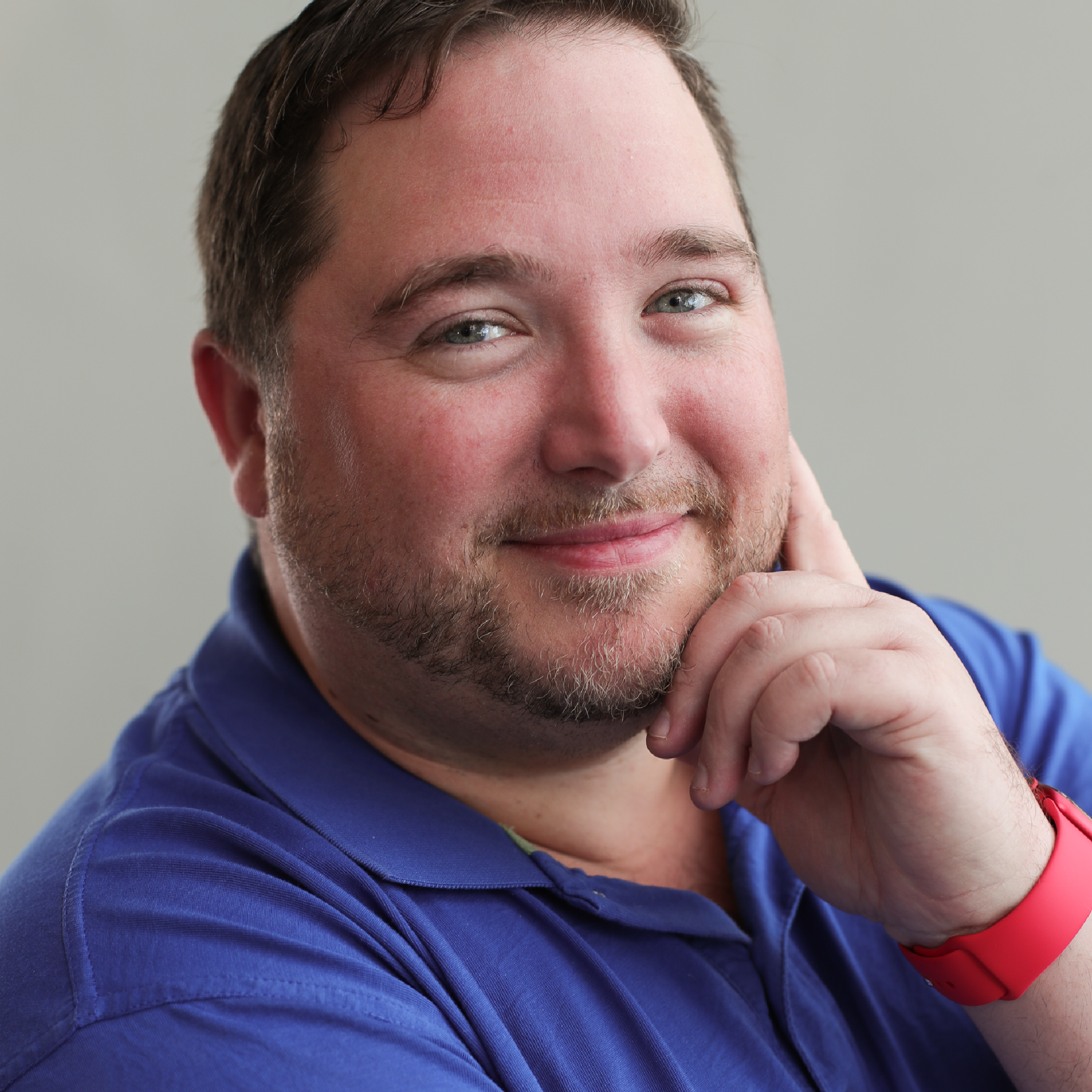 Scott Wismont, CTA. A man looks at the camera smiling with hand on chin. Travel Advisor Scott Wismont, CTA looks at the